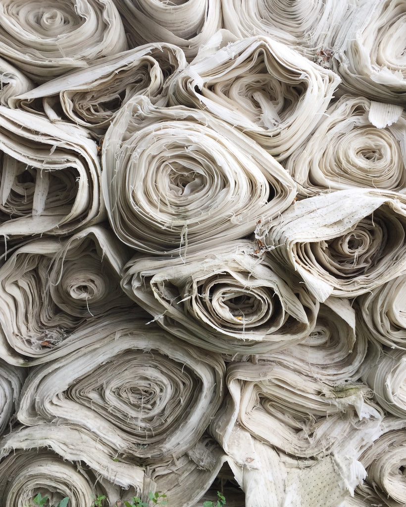 Rolls of fabric are pictured. At this is willow we use environmentally friendly fabrics like deadstock in our designs.